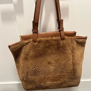 Furry. Very clean. No rips except on inside side pocket. Closes magnetically